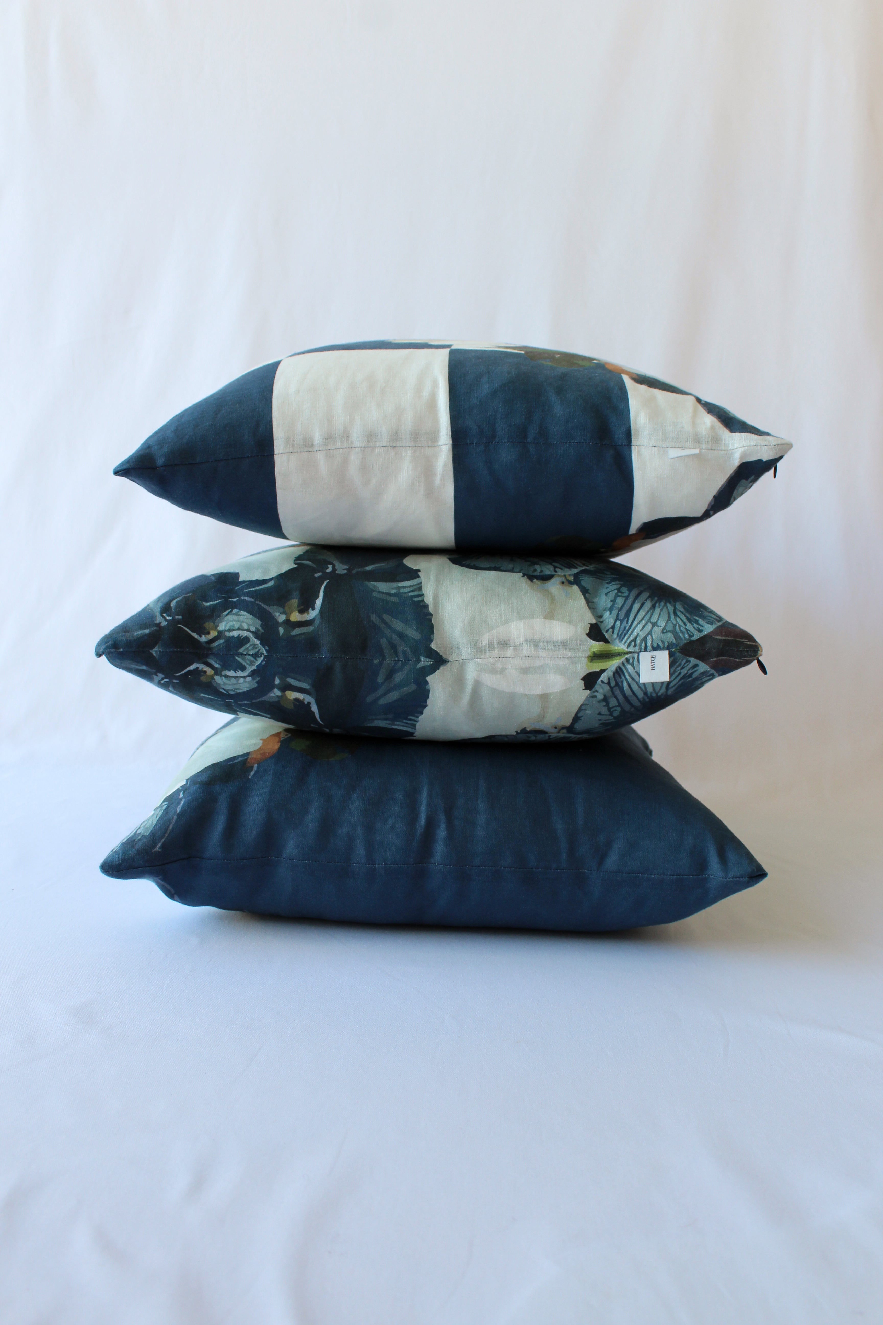 Navy checkered floral and solid coloured cushions styled perfectly as a trio