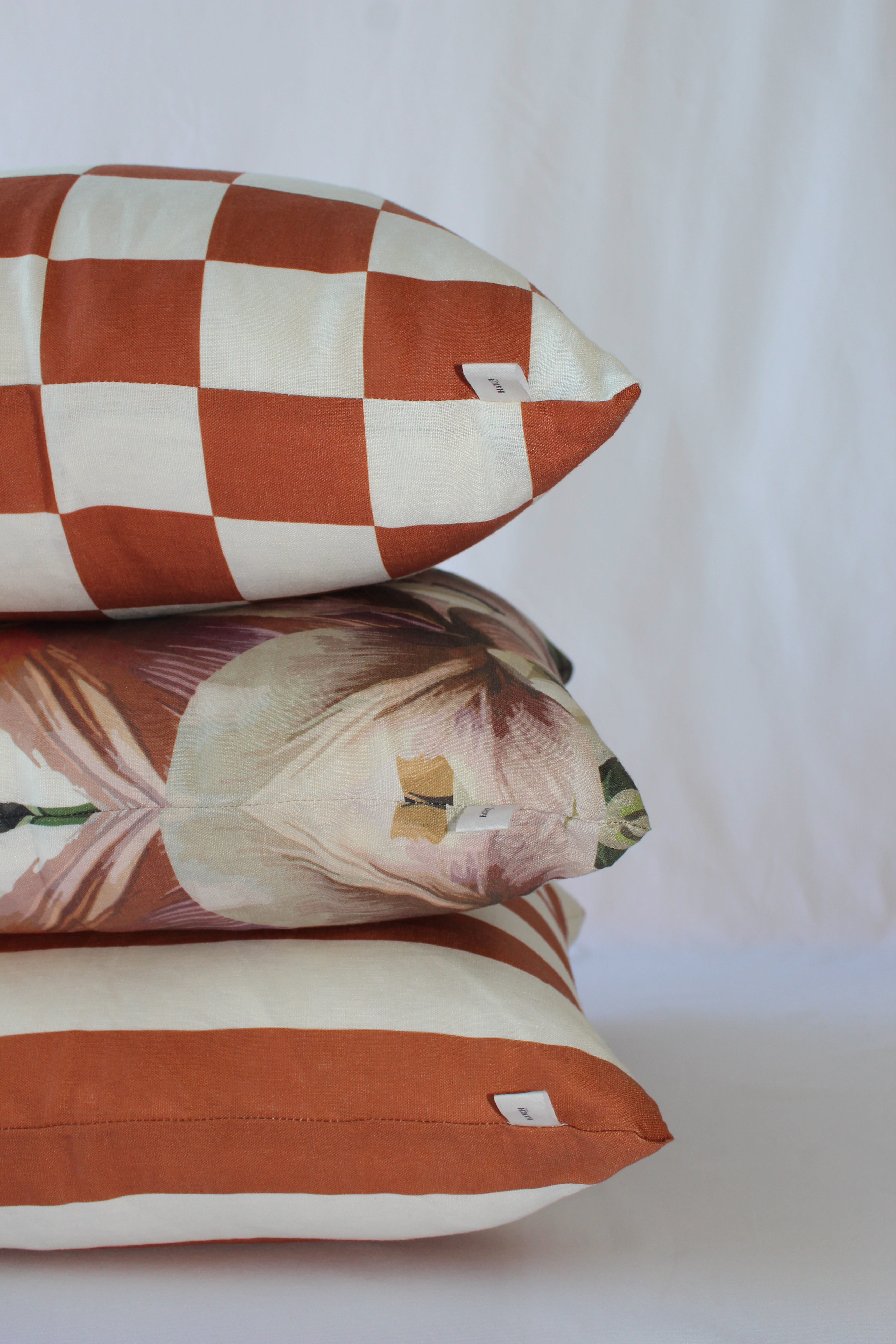 Orange cinnamon linen cushions paired in a trio