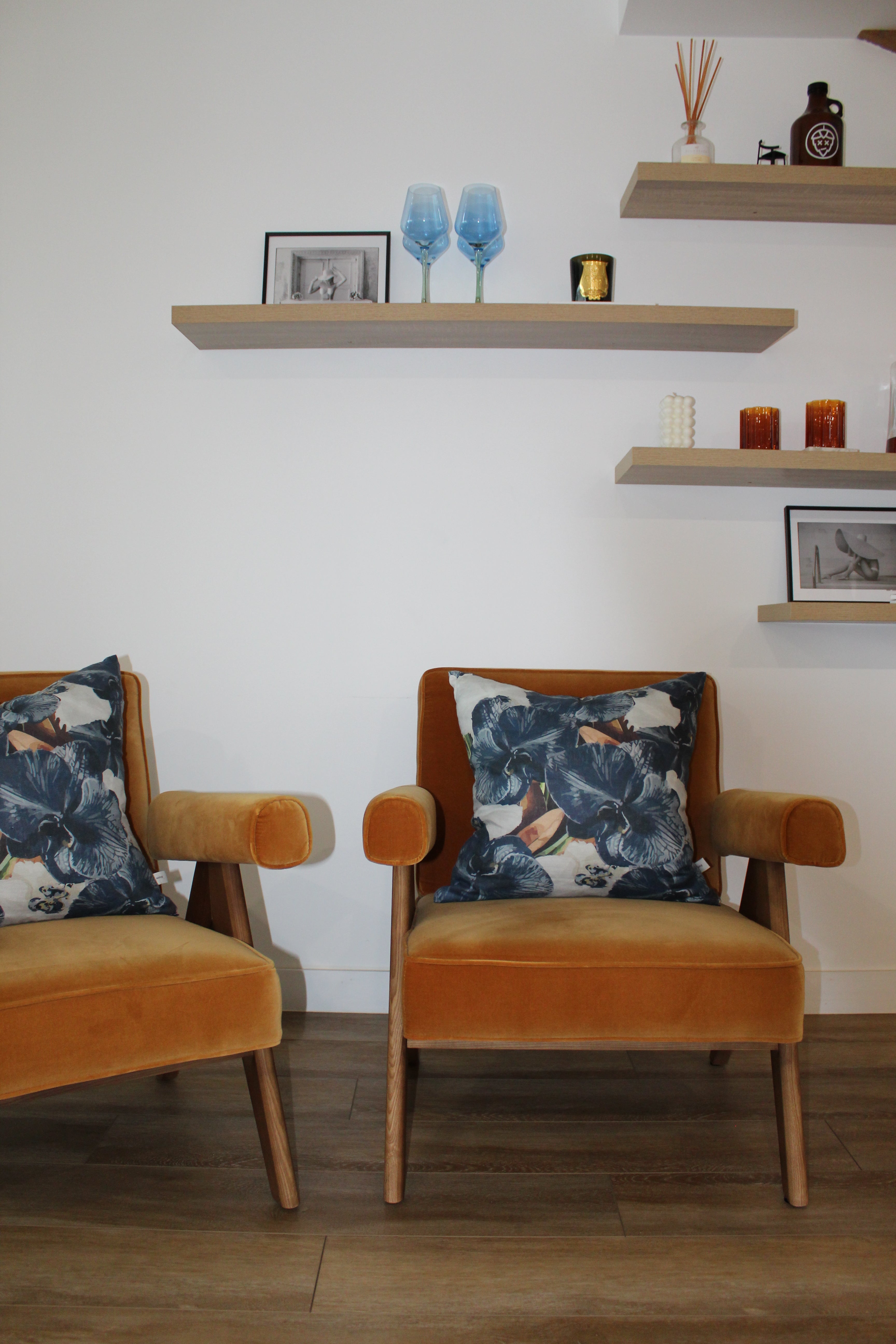 Navy slate floral linen cushions styled on modern rust armchair