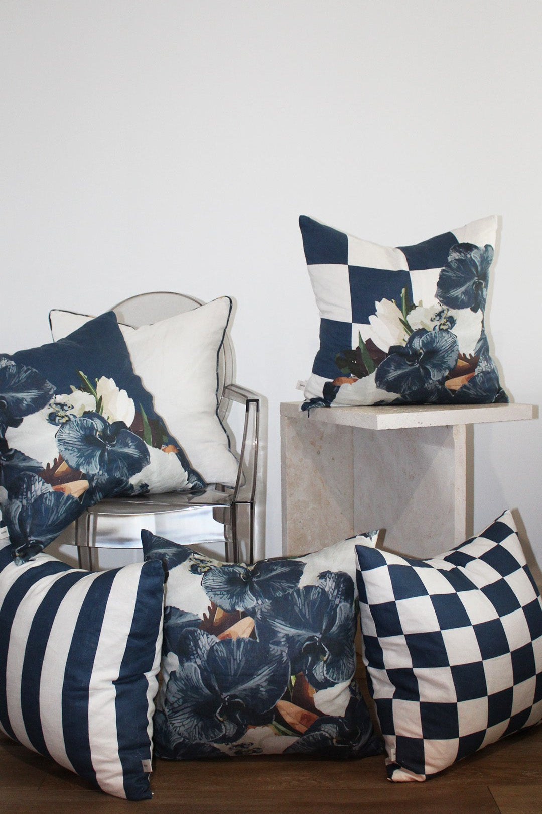 Collection of navy slate hue linen cushions styled in minimalist living room