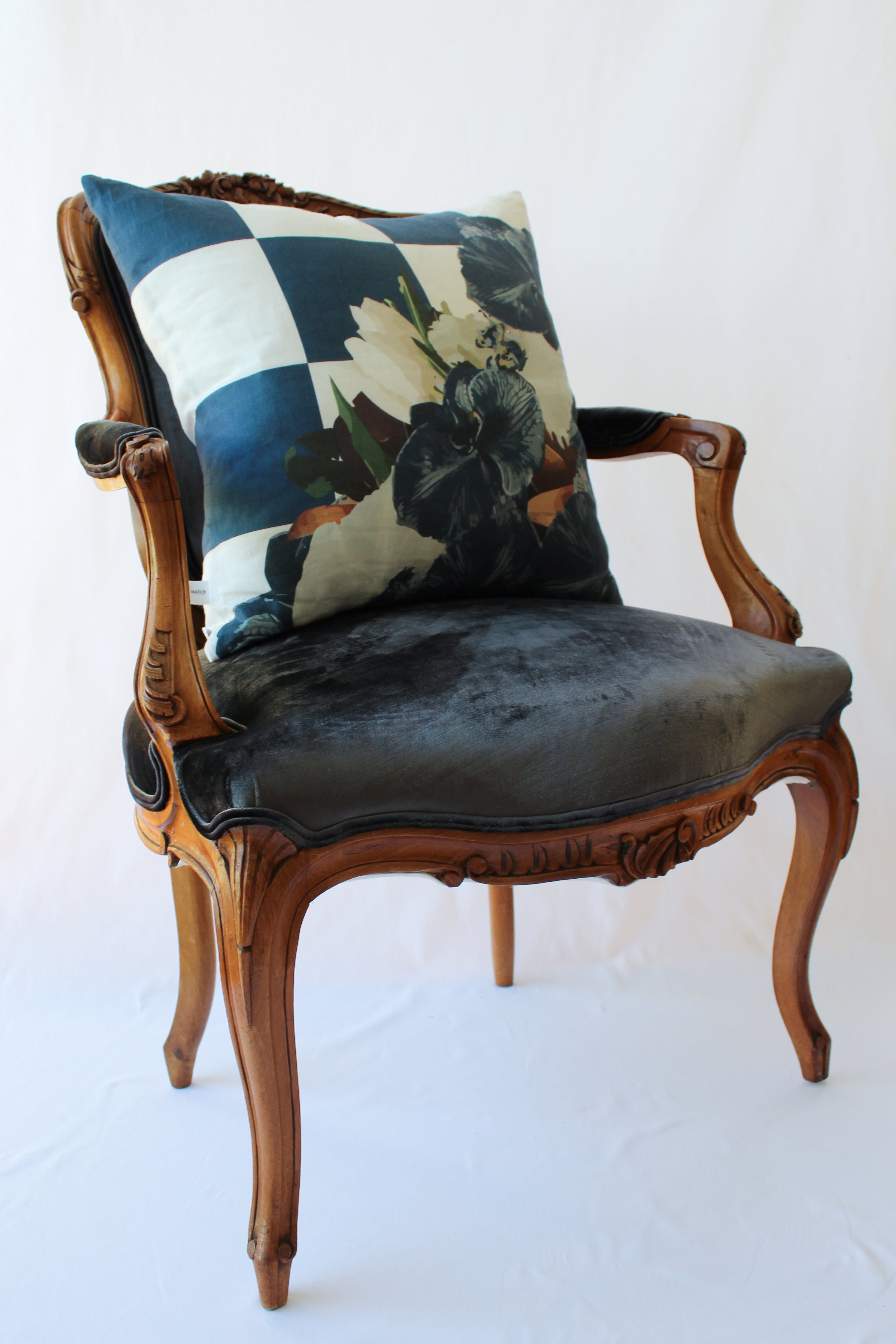 Navy slate floral and check linen cushion styled on a velvet chair