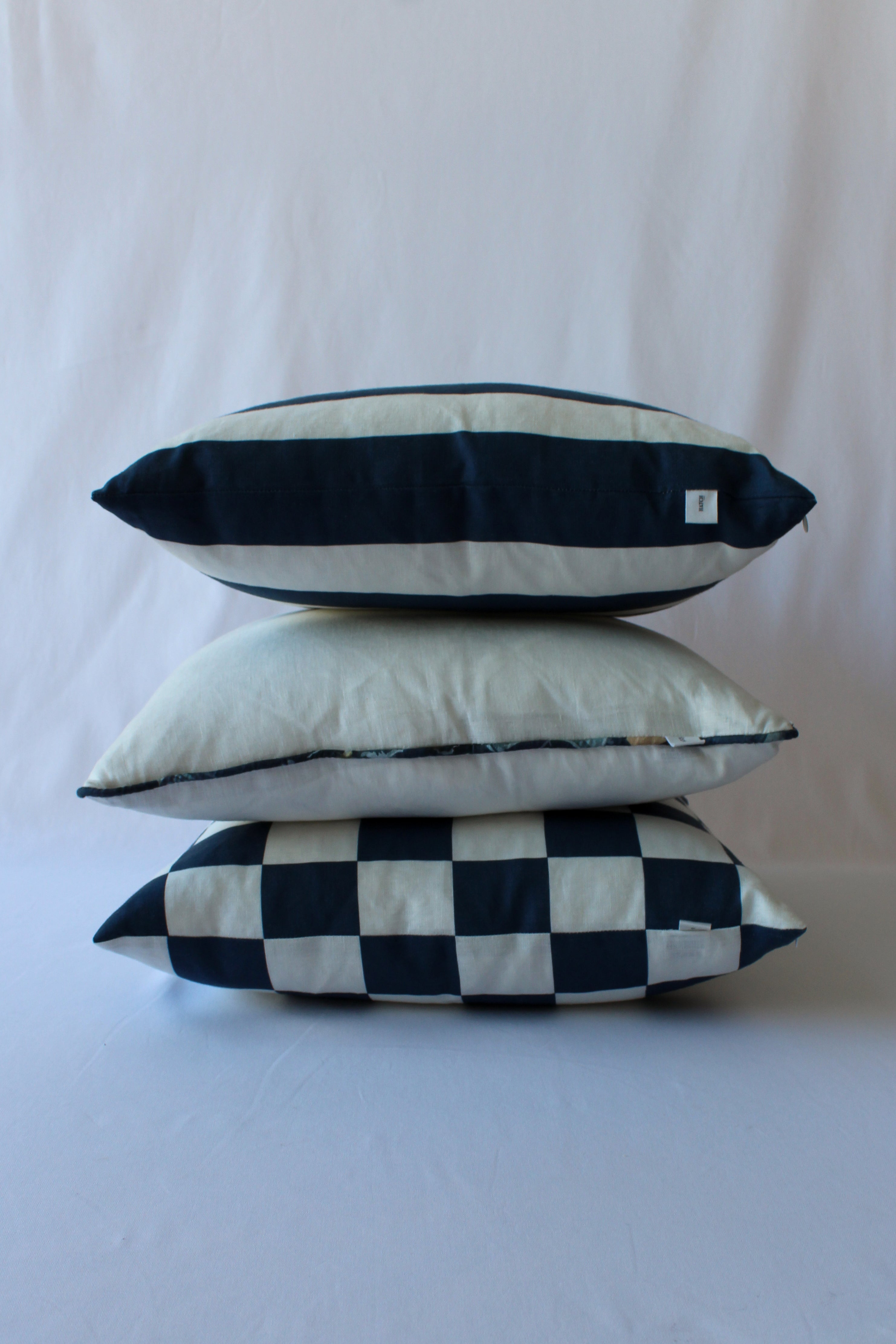 Trio of exclusive designer cushions in navy slate hues