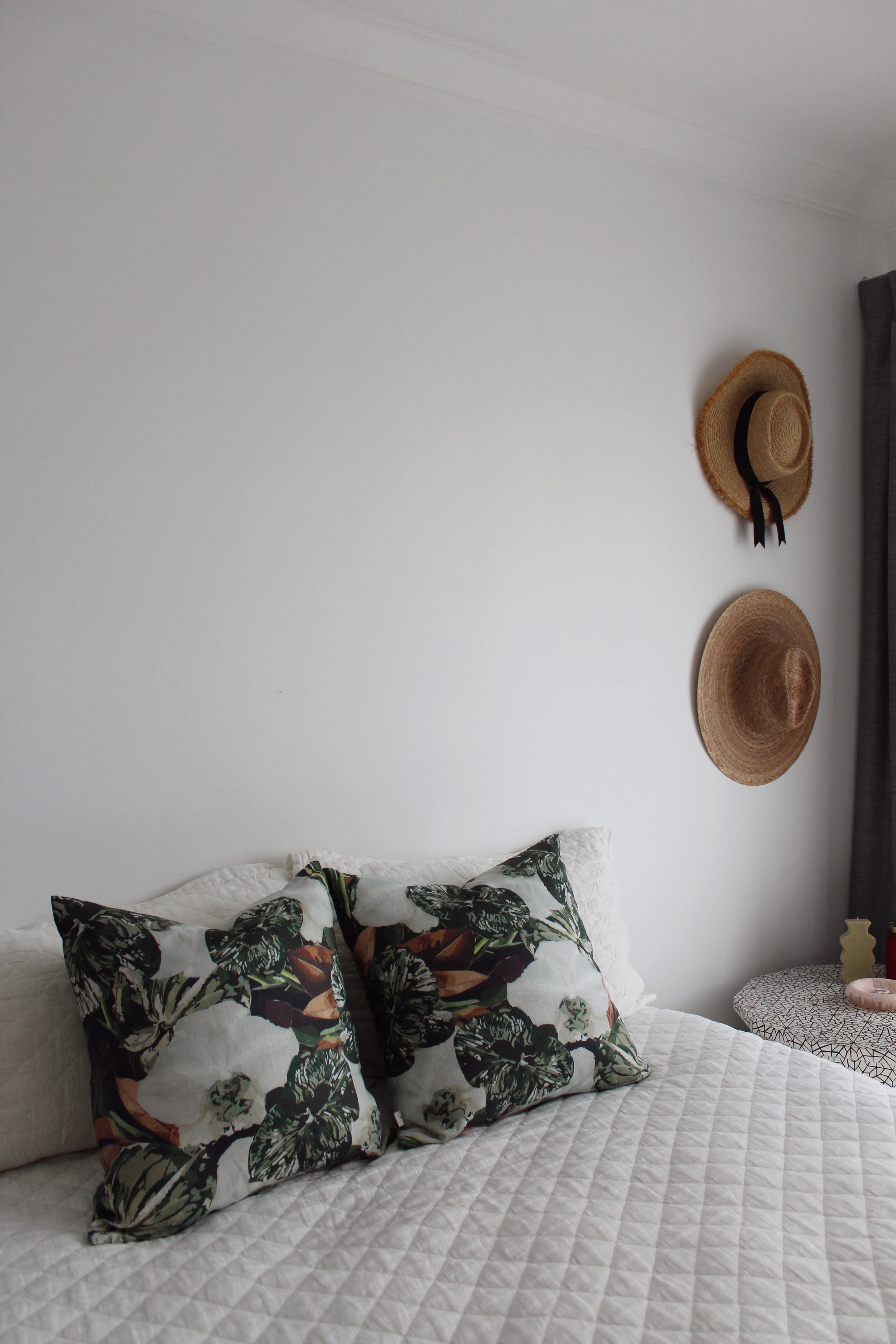 Pistachio green linen cushions styled on white linen bedding